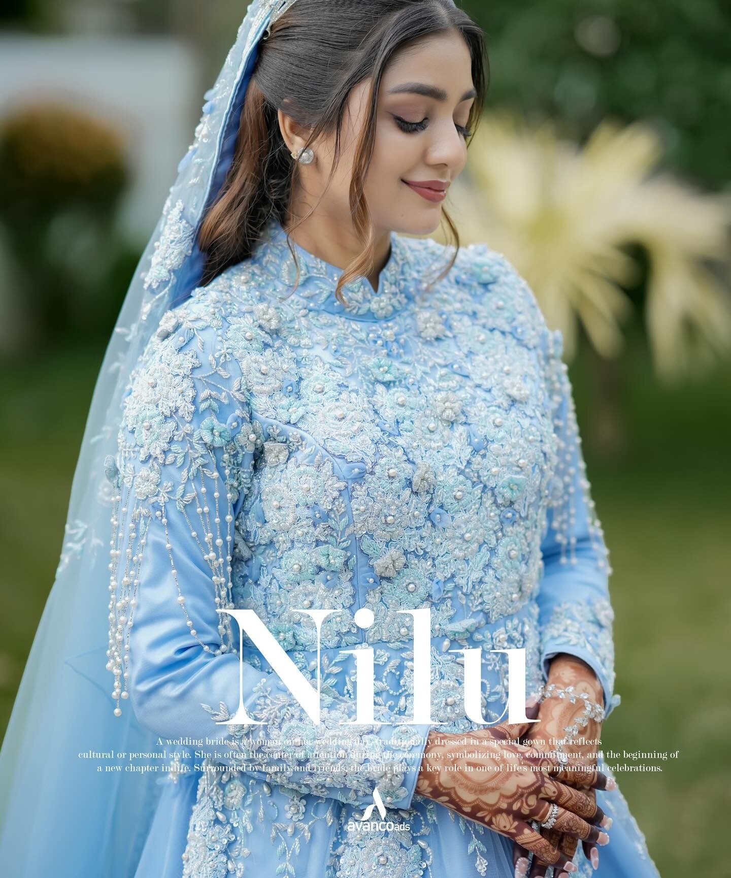 A bride in blue wedding attire in a garden portrait